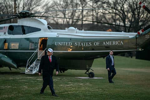 President Donald Trump disembarks Marine One on the South Lawn of the White House on Tuesday, January 13, 2026, after a trip to Detroit, Michigan.