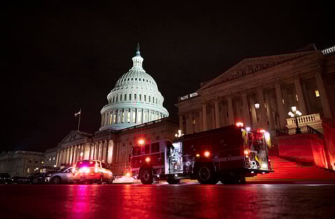 Emergency vehicles illuminate the U.S. Capitol after the January 6 attack disrupted the certification of the 2020 election.