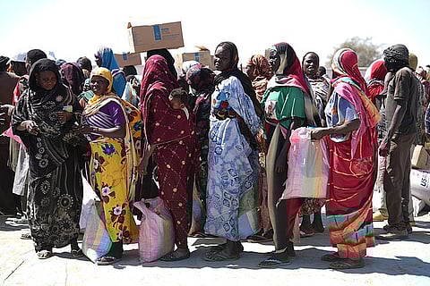 Sudanese refugees who have fled the conflict in Sudan register for food aid in neighbouring Chad.