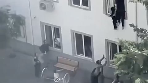 Terrified students  desperately climbing out of the building to escape the gunfire.