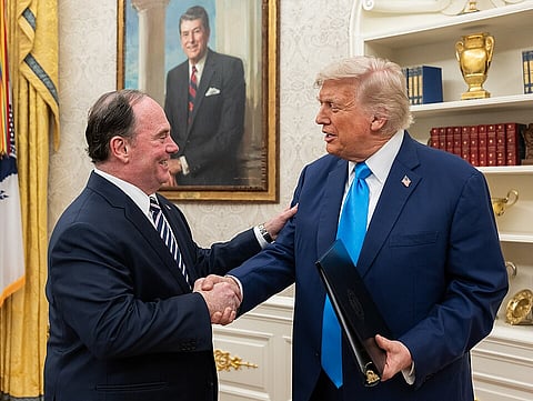 Donald Trump welcomes the Secretary of the Navy John Phelan after swearing-in at the White House Oval Office on June 6, 2025.