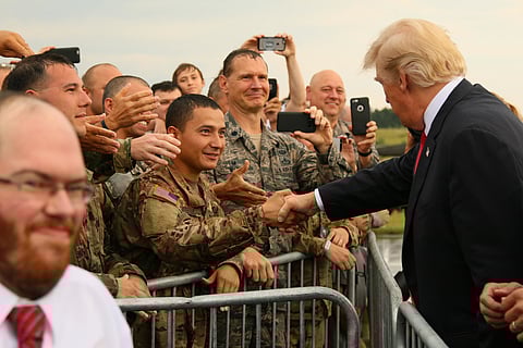 President Donald J. Trump greets service members after his arrival at the Raleigh County Memorial Airport near Beckley, W.Va. July 24, 2017.