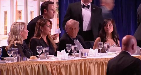 White House Correspondents' Dinner at the Washington Hilton, showing Secret Service agents about to rush President Trump off stage, April 25, 2026.