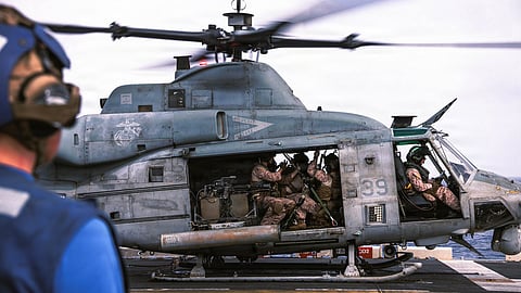 U.S. Marines with the 31st Marine Expeditionary Unit load onto a UH-1Y Venom aboard USS Tripoli (LHA 7).