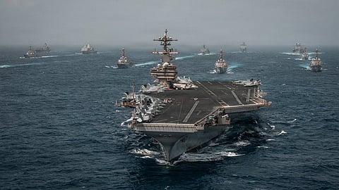 Massive U.S. Navy carrier strike group sails in formation to enforce the 'naval blockade' against Iranian ports.