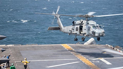 A U.S. Navy MH-60R Sea Hawk helicopter prepares to land on the flight deck aboard USS Boxer (LHD 4).
