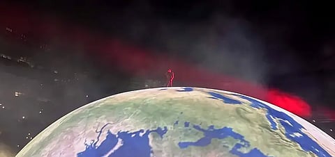 Kanye West performing on a globe-like stage as a red light flashes, 4 September 2026.