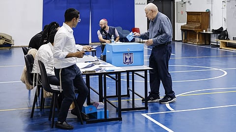 Israel election: no clear winner as exit polls show Likud largest party
