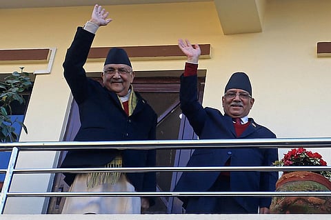 Nepal’s former guerrilla leader Pushpa Kamal Dahal, better known by his nom de guerre Prachanda waves next to Communist Party Nepal-Union Marxist Leninist (CPN-UML) chairman K.P. Sharma Oli in Bhaktapur on the outskirts of Kathmandu on December 25, 2022 before leaving for the President’s office to claim majority for his appointment as the new Prime Minister.