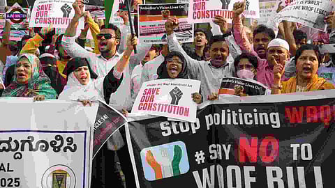 People raise slogans during a protest against the Waqf (Amendment) Act in Bengaluru.