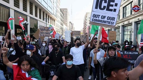 Demonstrators hold signs and flags during a protest against federal immigration sweeps in downtown Los Angeles, California, U.S. June 10, 2025.