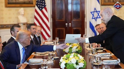 Israel’s Prime Minister Benjamin Netanyahu, right, hands President Donald Trump a folder during a meeting in the Blue Room of the White House, Monday, July 7, 2025, in Washington.