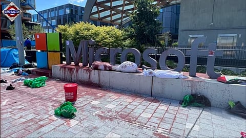 Protestors poured red paint over the Microsoft sign.
