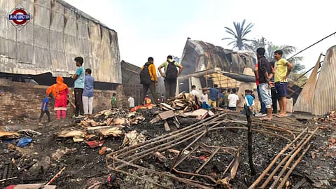 Kolkata: People gather near the charred remains of a fire at a warehouse, in Kolkata, Monday, Jan. 26, 2026. A fire broke out in a warehouse in the Nazirabad area of Anandapur. 