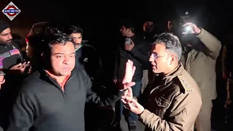 Delhi police personnel in plain clothes (left) and officials of Shimla Police seen arguing over the alleged arrest of AI Summit protest accused near Shimla on Wednesday. 