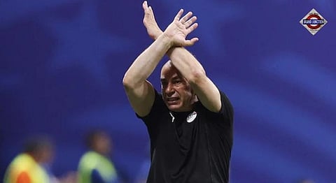 Egypt head coach Hossam Hassan makes FIFA's official anti-racism 'X' gesture while protesting Enzo Fernández's stoppage-time goal during Egypt's World Cup match against Argentina.