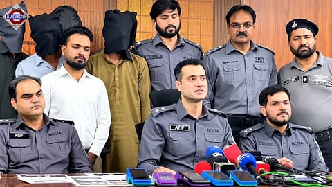Pakistani officials display seized electronic devices and those arrested during an October 19 press conference in Lahore.