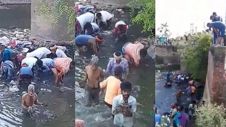 சாக்கடை கால்வாயில் கட்டுக் கட்டாக கிடந்த ரூ.2000 நோட்டு:  கழிவுநீரில் குதித்து அள்ளிச்சென்ற பொதுமக்கள்!