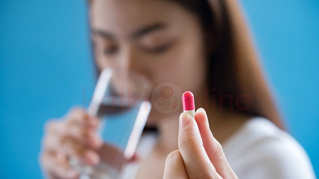 a woman take tablet