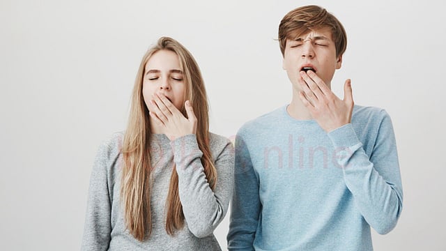 a man and woman yawning