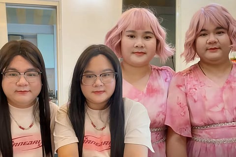 Chinese couple with similar looks, one in pink, one in casual wear