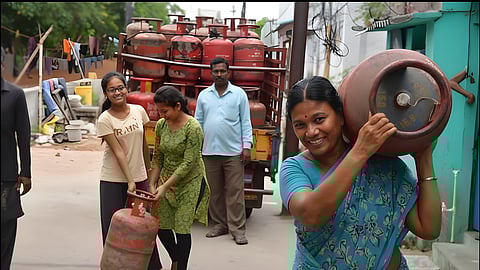 Women carrying LPG cylinders as families receive new gas supply