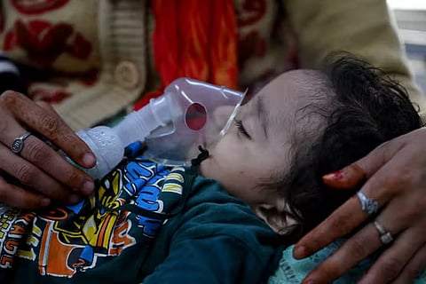 A child in a hospital in New Delhi, under a nebulizer,