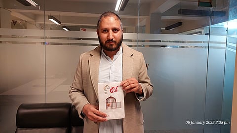 Danish Irshad with his book, "Azadi Kaay Baa’d" in Urdu.