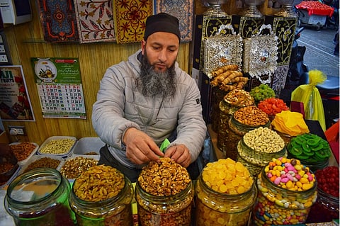 A shopkeeper displaying dry fruits and dates for sale as holy month of Ramadan begins in Srinagar on March 2, 2025.