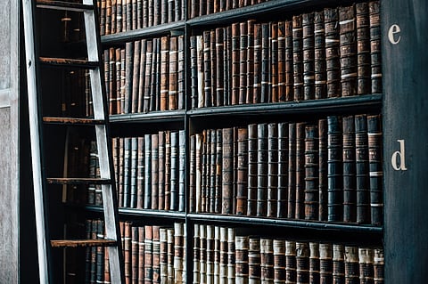 Historical books in a bookshelf in a library. Representative image.