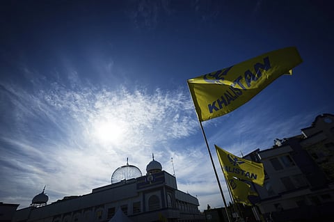 Khalistan flags are seen outside the Guru Nanak Sikh Gurdwara Sahib in Surrey, British Columbia, Canada, where temple president Hardeep Singh Nijjar was gunned down in his vehicle while leaving the temple parking lot in June, 2024. 