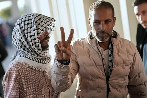 Global Sumud Flotilla activists deported from Israel give the peace sign after arriving at Istanbul Airport in Turkiye.
