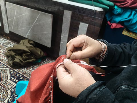 Master Manzoor from Kadipora, Anantnag weaves intricate tales of Kashmir’s heritage into the folds of a Pheran in Kashmir.