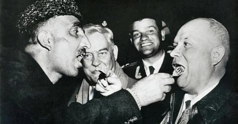 Jammu and Kashmir Prime Minister Bakshi Ghulam Mohammad thrusting Goshtaba into Nikita Khrushchev's mouth in Srinagar during the latter's visit to Srinagar in December 1955.