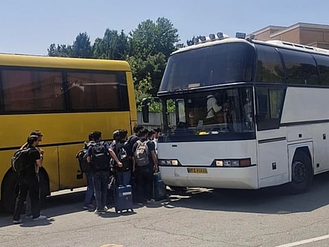 Indian students board buses in Tehran arranged by the Indian Embassy for evacuation amid ongoing tensions in Iran.