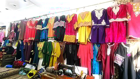 A view of the shop showcasing embroidered Pheran for ceremonial occasion for women in Kashmir.