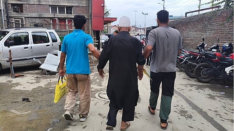 An elderly man, supported by his two sons, walks toward the emergency ward of the SMHS Hospital, Srinagar. Image is representational.