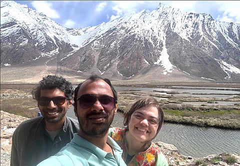The author, Dr Aditi Parimoo with two Anands by the river side in the backdrop of snow-clad mountains, during a trip to Ladakh region.