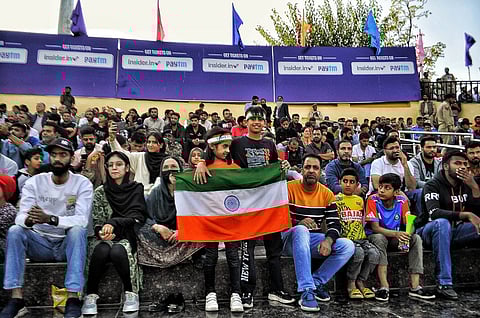 A small boy and girl show the Indian flag during the Legends League Matches 2024 in Kashmir. Photo/Sahil Mir
