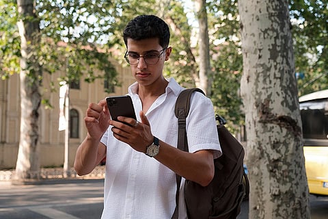 صورة شاب يستخدم الهاتف