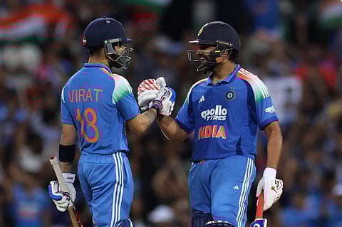 India's Rohit Sharma and Virat Kohli celebrate after winning the 3rd ODI match against Australia  in Sydney.