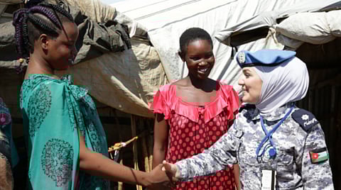 African women shaking hands an international military personnel.