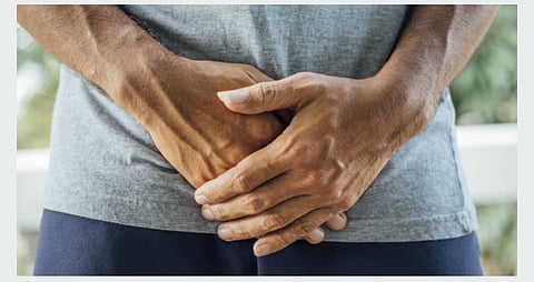 Man covering his genital organ