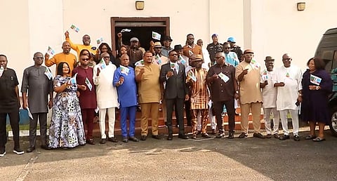 The 27 lawmakers wave APC flag after a meeting at the Assembly Complex on Monday, December 11, 2023