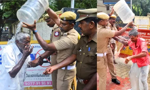 தீக்குளிக்க முயன்றவர்களை தடுத்து அவர்கள் மீது போலீசார் தண்ணீர் ஊற்றிய காட்சி.
