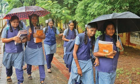 மழையில் நனைந்தபடி பள்ளிக்ளுக்கு சென்ற மாணவ-மாணவிகளை படத்தில் காணலாம்.
