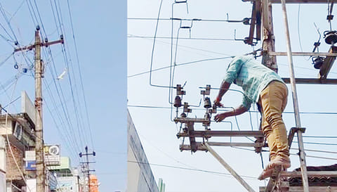 மின்கம்பிகளை சரிசெய்யும் பணியில் ஊழியர்கள்.