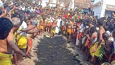 தீக்குண்டத்தில் பக்தர் ஒருவர் தீமிதித்த போது எடுத்த படம்.