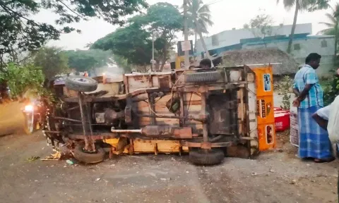 சாலையில் கவிழ்ந்து கிடக்கும் லாரி.
