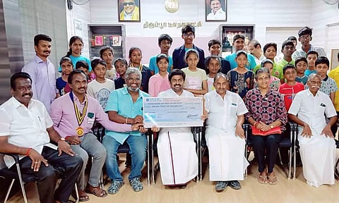 மேயர் தினேஷ்குமாரிடம் காசோலை வழங்கிய காட்சி.